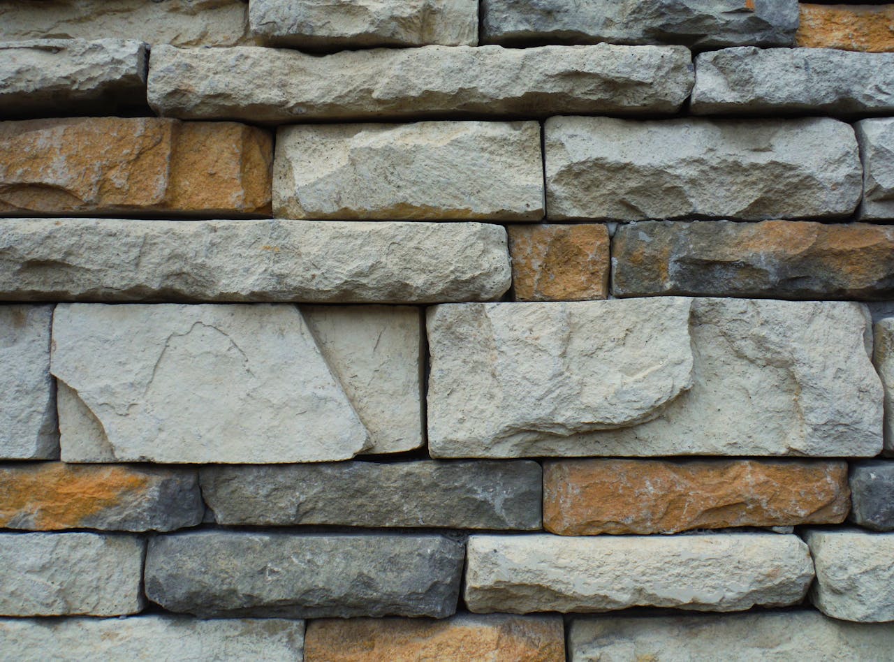 hero-img-01 Close-up of a textured stone wall with a variety of natural colors.