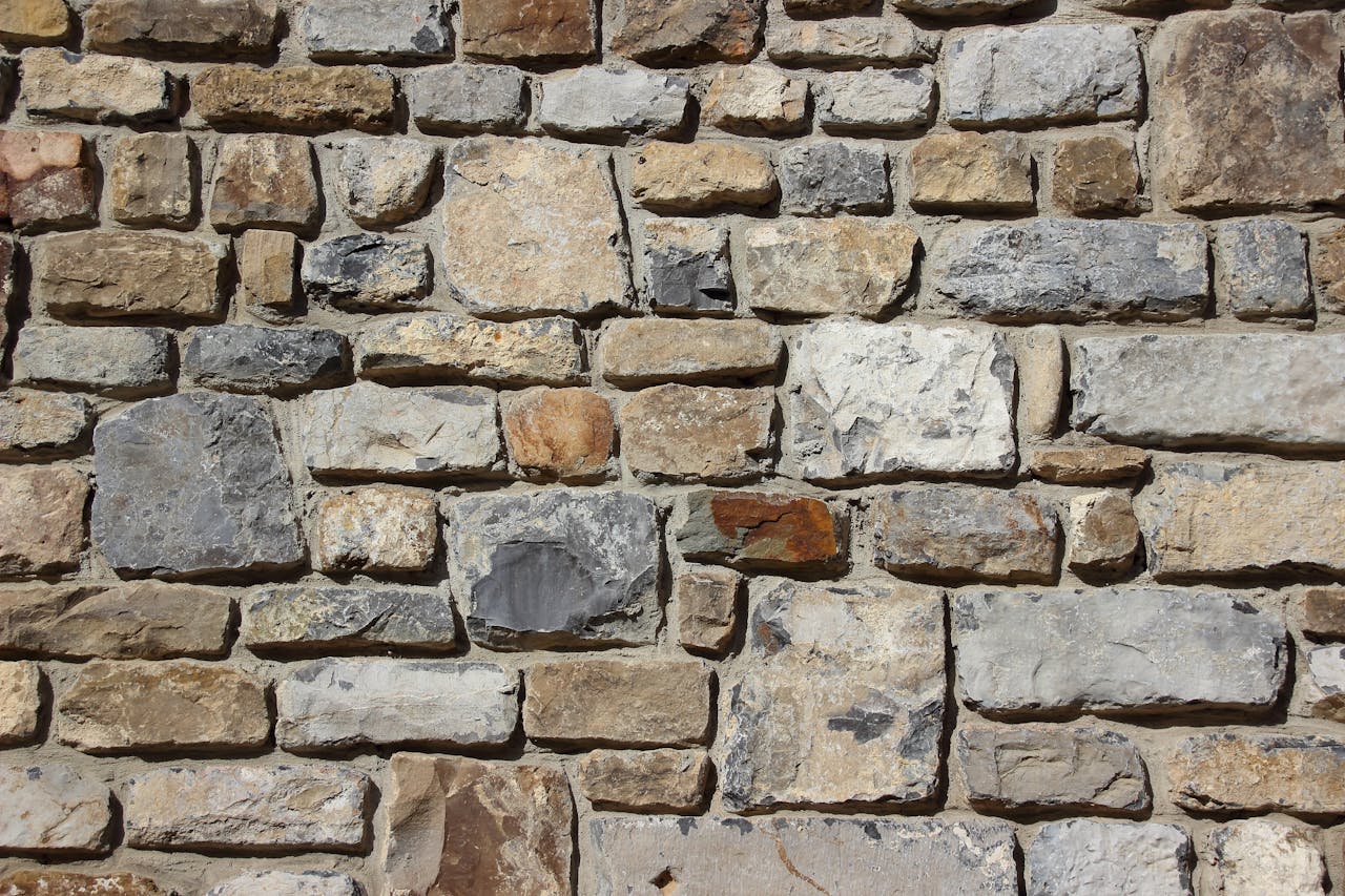 our-services-1 Detailed image of a textured stone wall, showcasing various shades and shapes.
